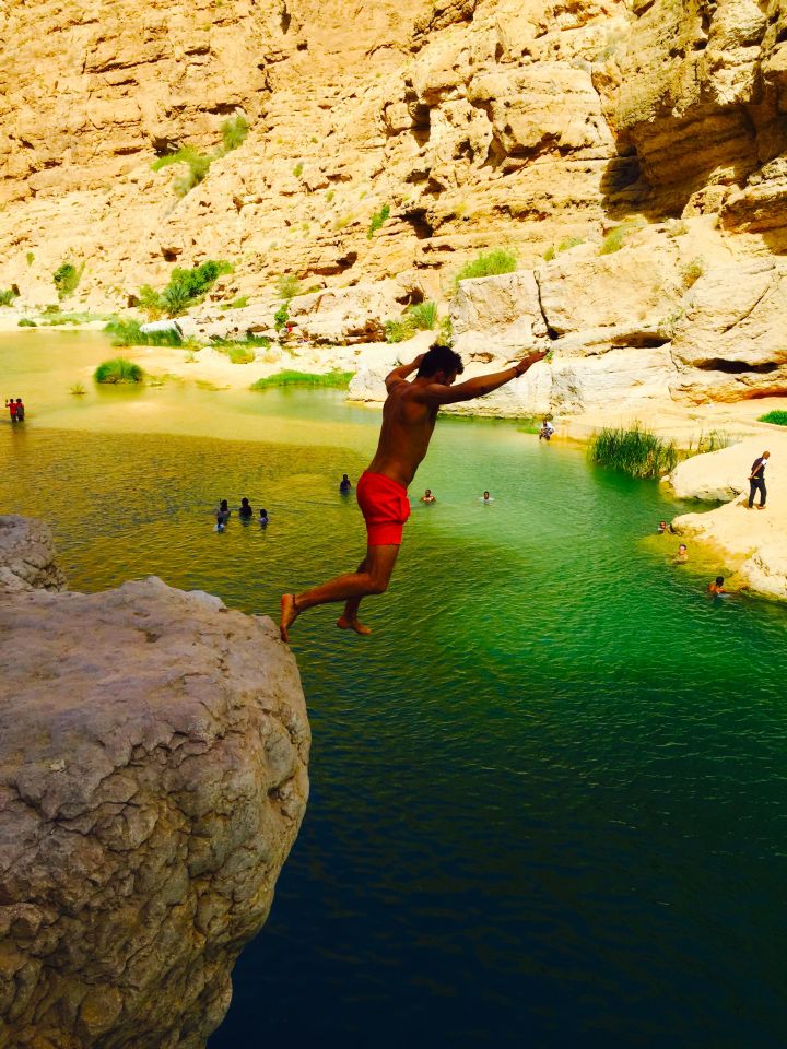 Jumping off a cliff in Wadi Shab Oman